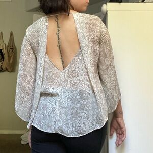 Beige floral print blouse with open back detail